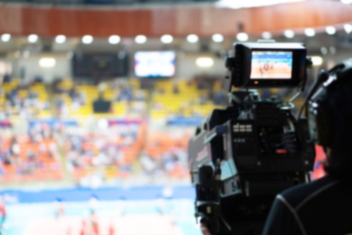 Blurred background of professional volleyball league cup championship international competition live sport news tv show from indoor arena with fans crowd cheer up and watching from stand for victory